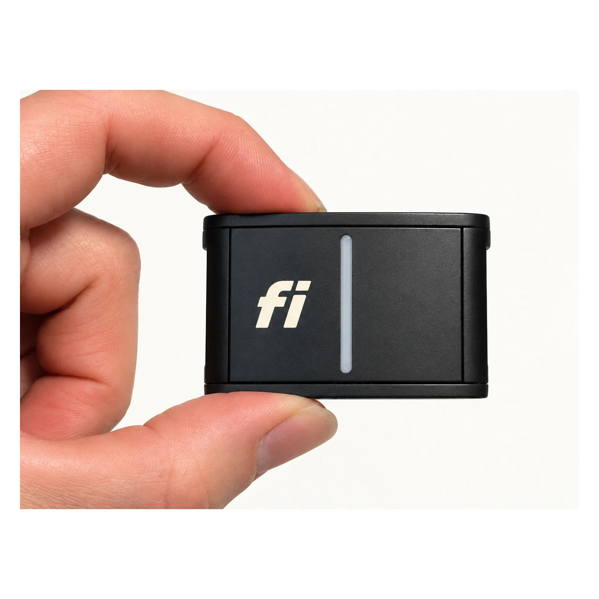 Fi Series 3 GPS tracker module held between fingers on a clean white background